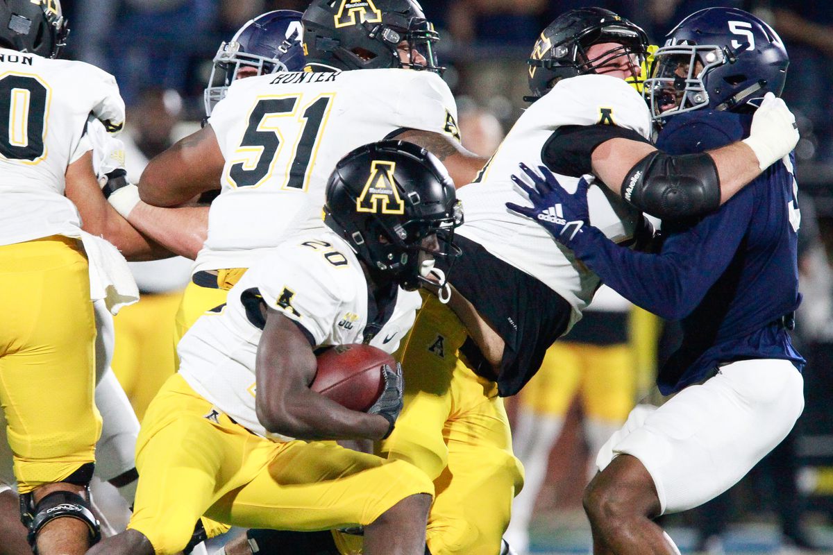 Nate Noel #20 of the Appalachian State Mountaineers tries to maneuver through the Georgia Southern Eagles defense during the first half at Allen E. Paulson Stadium on December 12, 2020 in Statesboro, Georgia.