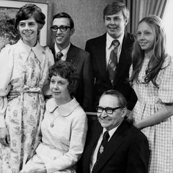 L. Tom and Virginia Clare Lee Perry family photograph, April 6, 1974, the day Elder Perry was sustained as a member of the Quorum of the Twelve. Standing: Perry Haws, Terry D. Haws, Lee Perry, and Linda Gay Perry. Seated: Sister and Elder Perry.