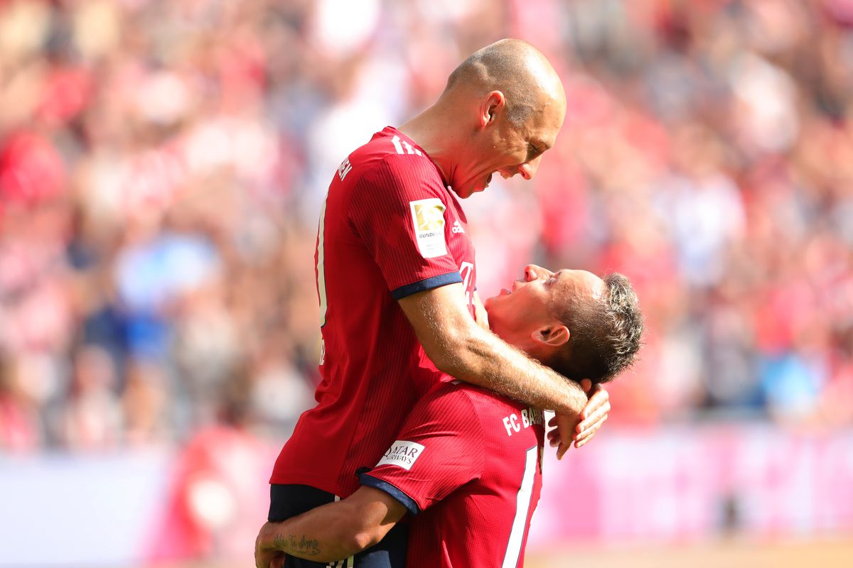 MUNICH, GERMANY - SEPTEMBER 15: Arjen Robben of Bayern Munich celebrates with teammate Rafinha after scoring his team's second goal during the Bundesliga match between FC Bayern Muenchen and Bayer 04 Leverkusen at Allianz Arena on September 15, 2018 in Munich, Germany. 