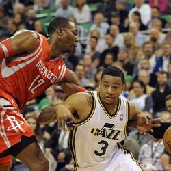 Utah Jazz point guard Trey Burke (3) drives around the defense of Houston Rockets power forward Dwight Howard (12) during a game at EnergySolutions Arena on Monday, Dec. 2, 2013.