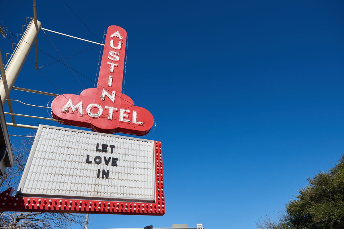 Austin Motel sign with a marquee that says “Let Love In”