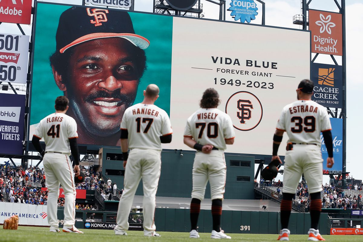 Wilmer Flores, Mitch Haniger, Brett Wisely, and Thairo Estrada standing in front of the scoreboard honoring the passing of Vida Blue