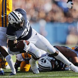 Brigham Young Cougars running back Squally Canada (22) runs under McNeese State Cowboys defensive back Trent Jackson (9) in Provo on Saturday, Sept. 22, 2018.