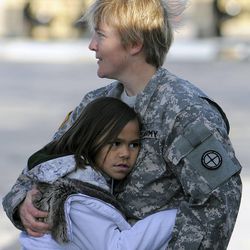 Nine-year-old Leilani Ward gives a big hug to Chief Warrant Officer 3 Kayce Lowry before Lowry prepares to fly out with eight other soldiers of the Utah Army National Guards 2nd Battalion, 211th Aviation, on two UH-60 Blackhawk helicopters for the first leg of their 12-month deployment to Kosovo from the Utah Guards Army Aviation Support Facility in West Jordan on Saturday, November 23, 2013. The remaining 49 soldiers will join up with their unit on Sunday as they will leave from Salt Lake International Airport and rendezvous at Fort Hood in Texas.
