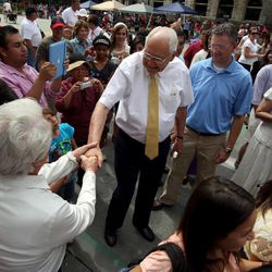 Elder L. Tom Perry is surrounded by people who want to talk to him as he leaves the Days of '47 Parade in Salt Lake City on Wednesday, July 24, 2013. 