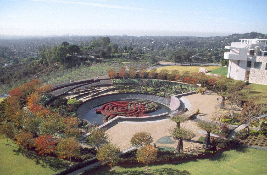 An aerial view of the Fran and Ray Stark Sculpture Garden in Los Angeles. There are trees on the outer perimeter and a labyrinth maze garden in the interior.