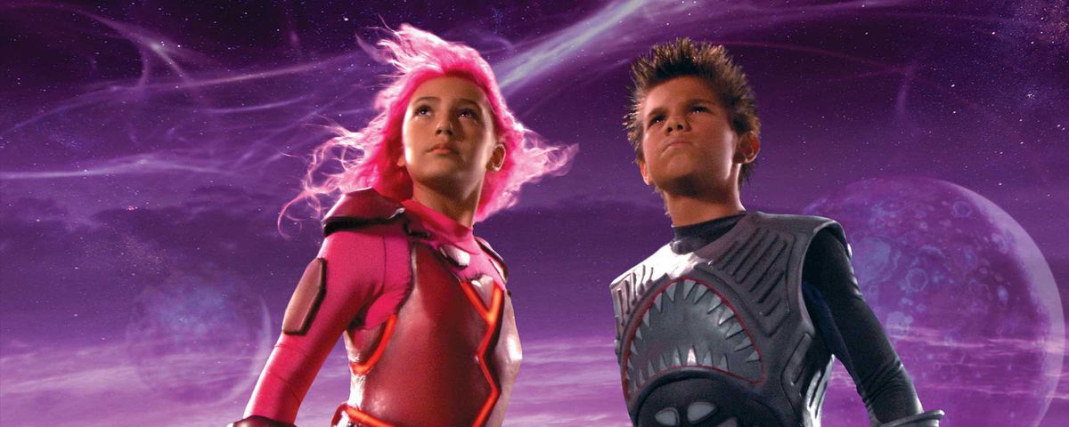 Two kids dressed as superheroes.
