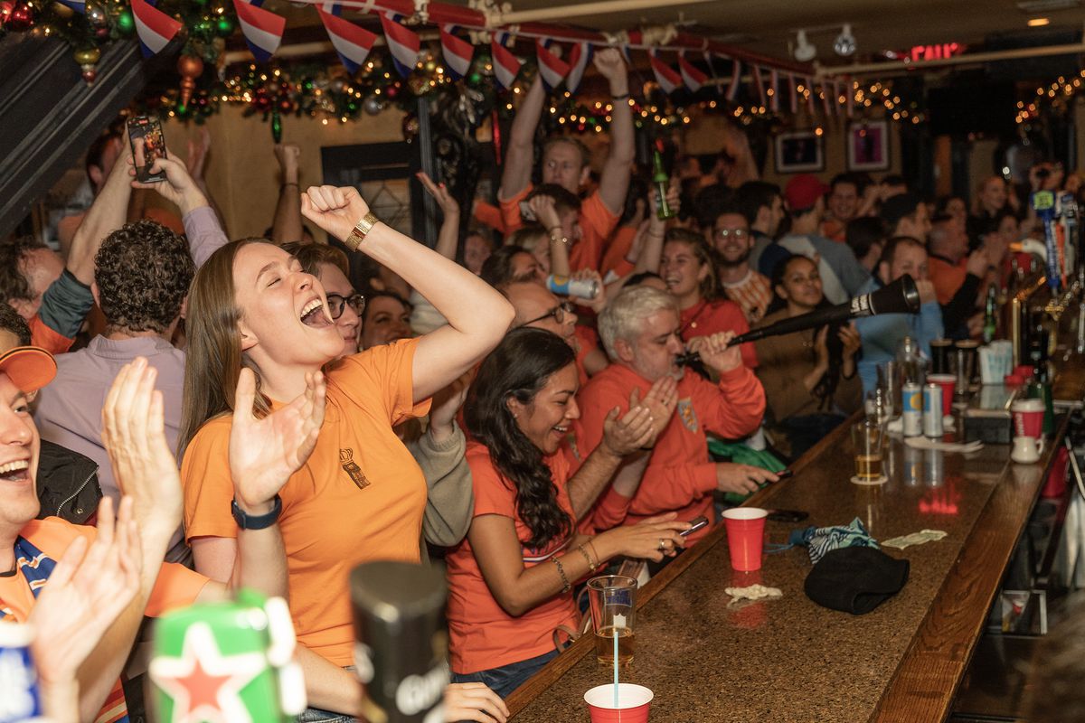 Fans of The Netherlands football team reacting and drinking...