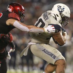 San Diego State’s Troy Cassidy can’t stop Utah State’s Jaylen Warren from scoring a touchdown during the second quarter of an NCAA college football game Saturday, Sept. 21, 2019, in San Diego. (Hayne Palmour IV/The San Diego Union-Tribune via AP)