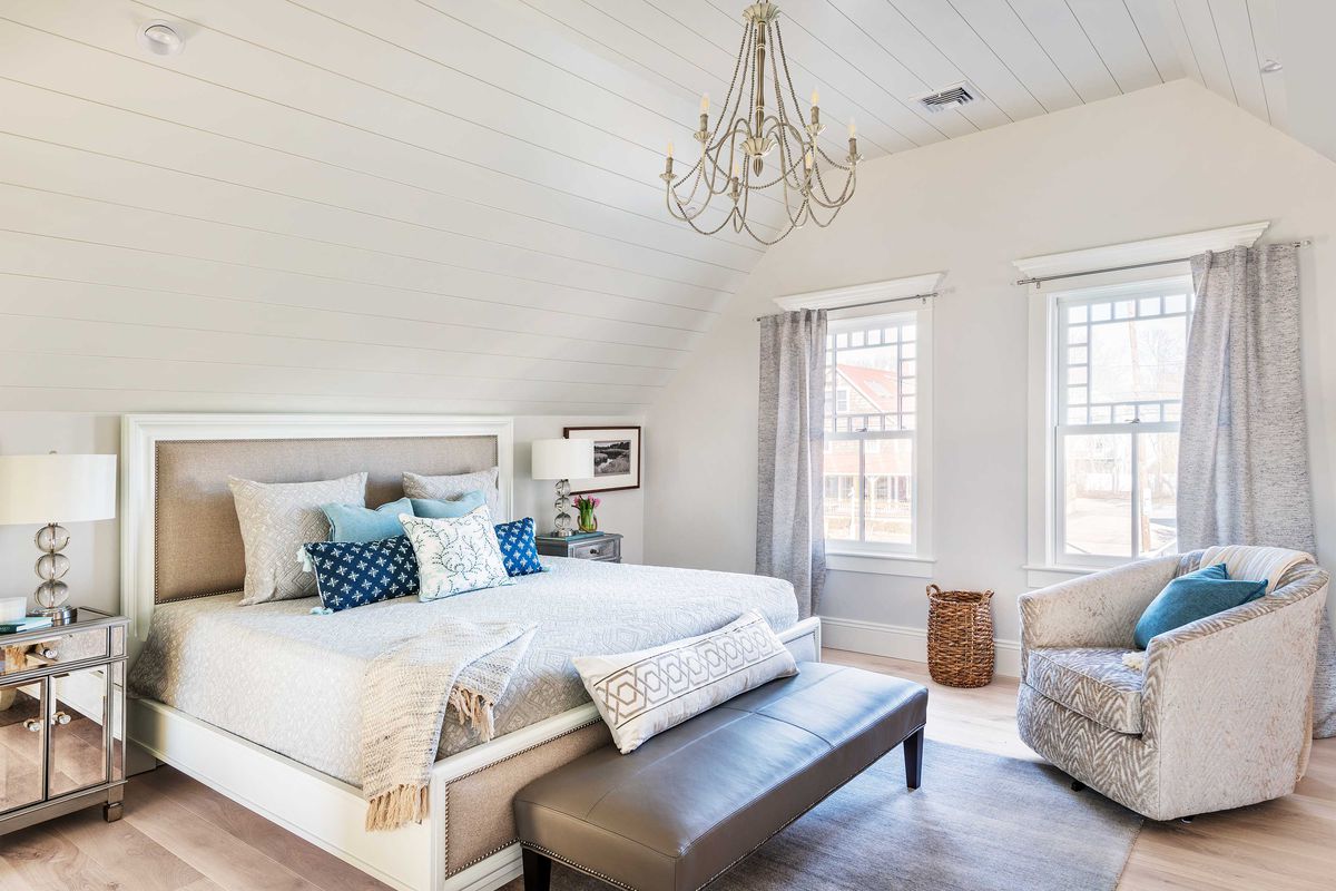 Neutral colored bedroom with shiplap ceilings.