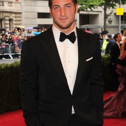 Tim Tebow says he's blessed to be at the Met Ball and is wearing Ralph Lauren purple label. He's blessed to fit in it; that line is not cut for football players.