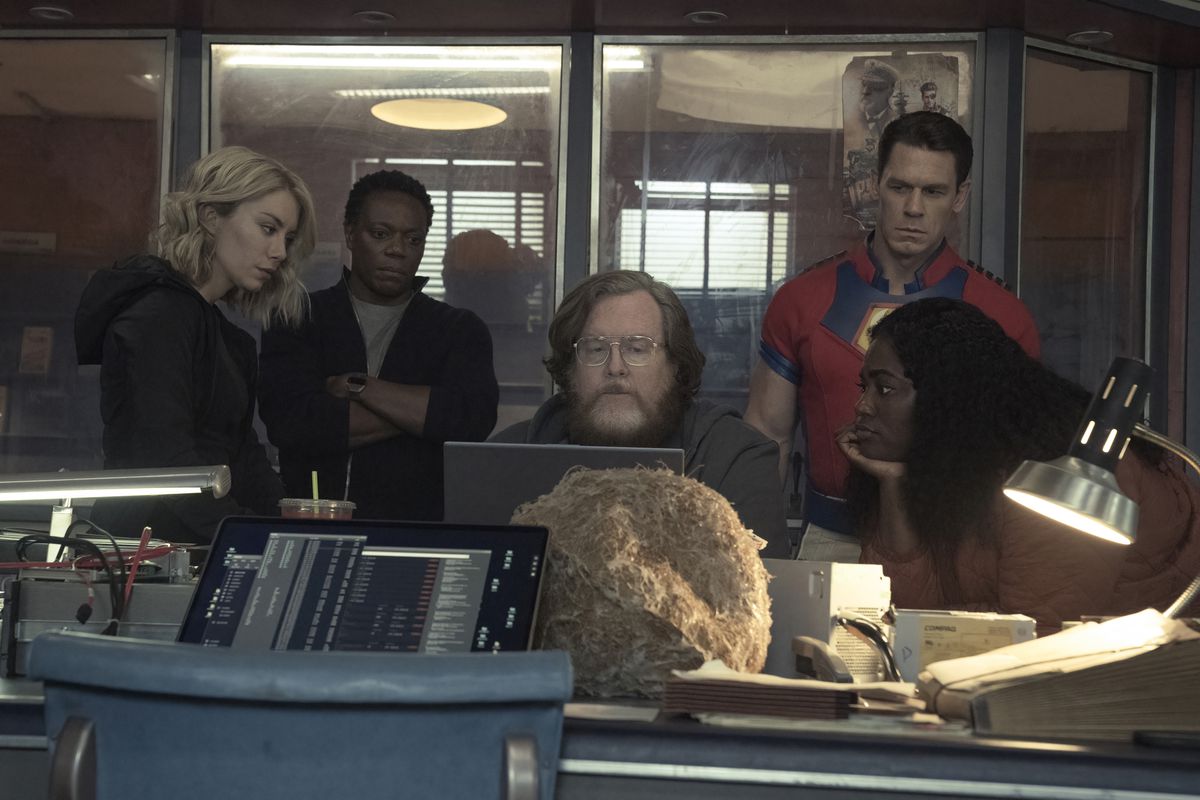 Team Peacemaker gathered around the computer in season 1