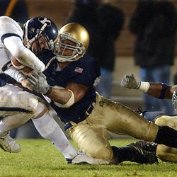 Brigham Young University quarterback is sacked by  University of Notre Dame's Courtney Watson and Darrell Campbell in action Nov 15th, 2003 in South Bend, Indiana.   (Submission date: 11/15/2003)