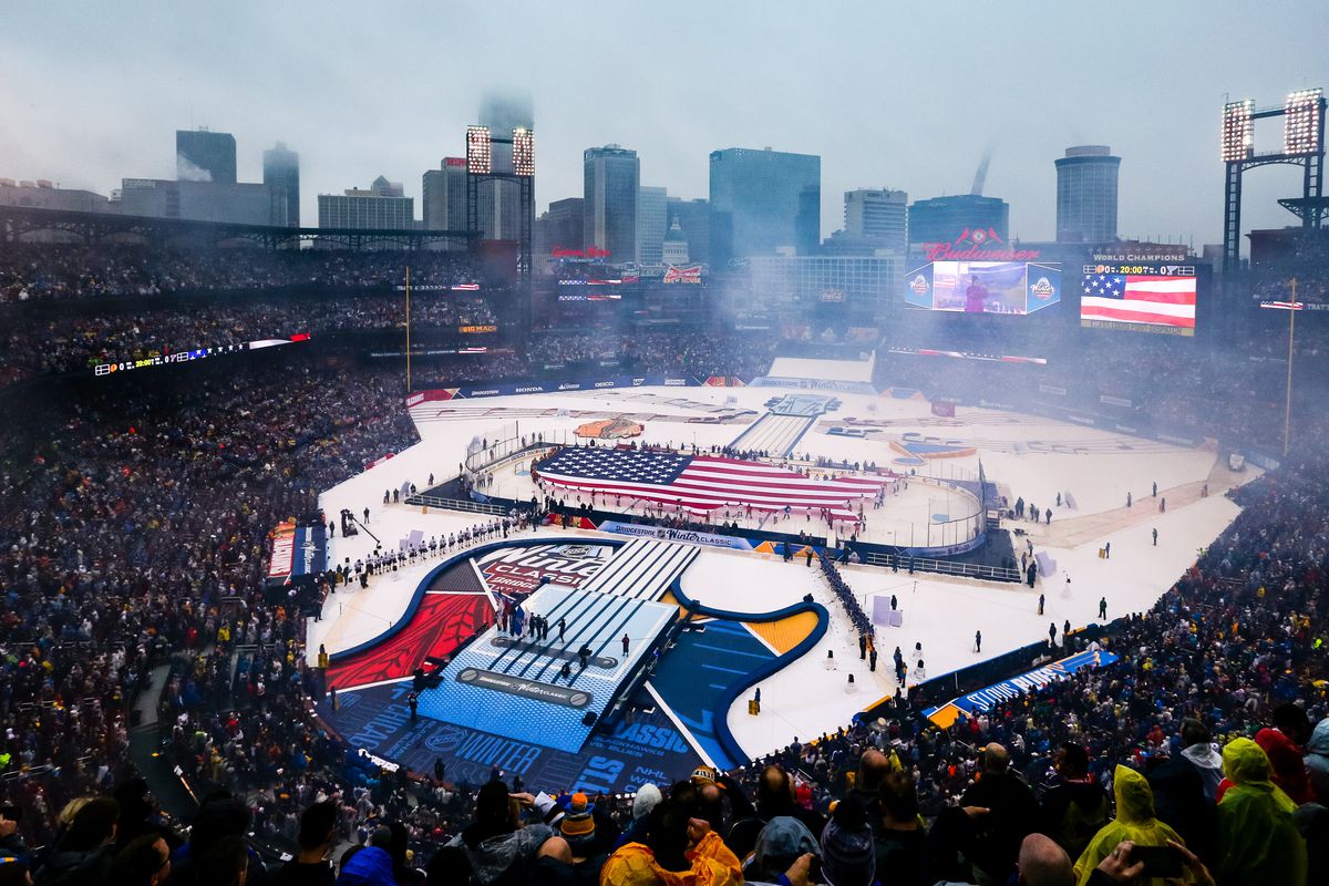 ST. LOUIS, MO - JANUARY 02:  An American flag is stretched out on the ice during the National Anthem before the start of a NHL Winter Classic hockey game between the Chicago Blackhawks and the St. Louis Blues on January 2, 2017, at Busch Stadium in St. Louis, MO.  (Photo by Tim Spyers/Icon Sportswire via Getty Images)