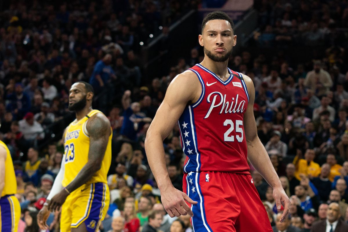 Philadelphia 76ers guard Ben Simmons reacts after dunking the ball during the fourth quarter as Los Angeles Lakers forward LeBron James looks on in the background at Wells Fargo Center.&nbsp;