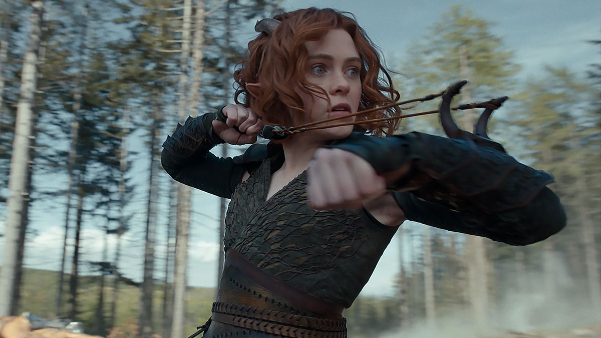 Doric the tiefling druid (Sophia Lillis) prepares to fire a wrist-mounted slingshot at something offscreen in Dungeons &amp; Dragons: Honor Among Thieves