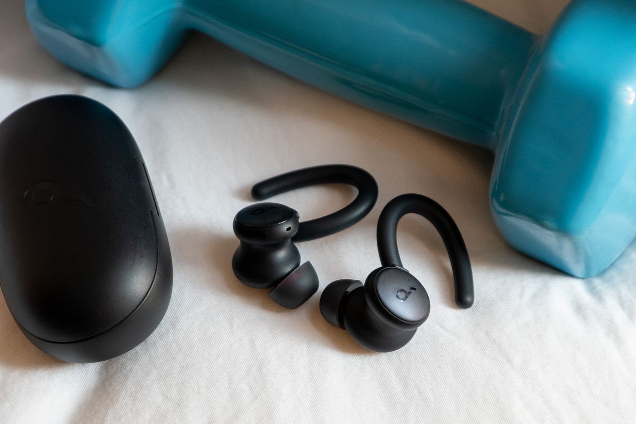 An image of Soundcore’s Sport X10 earbuds next to a weight.