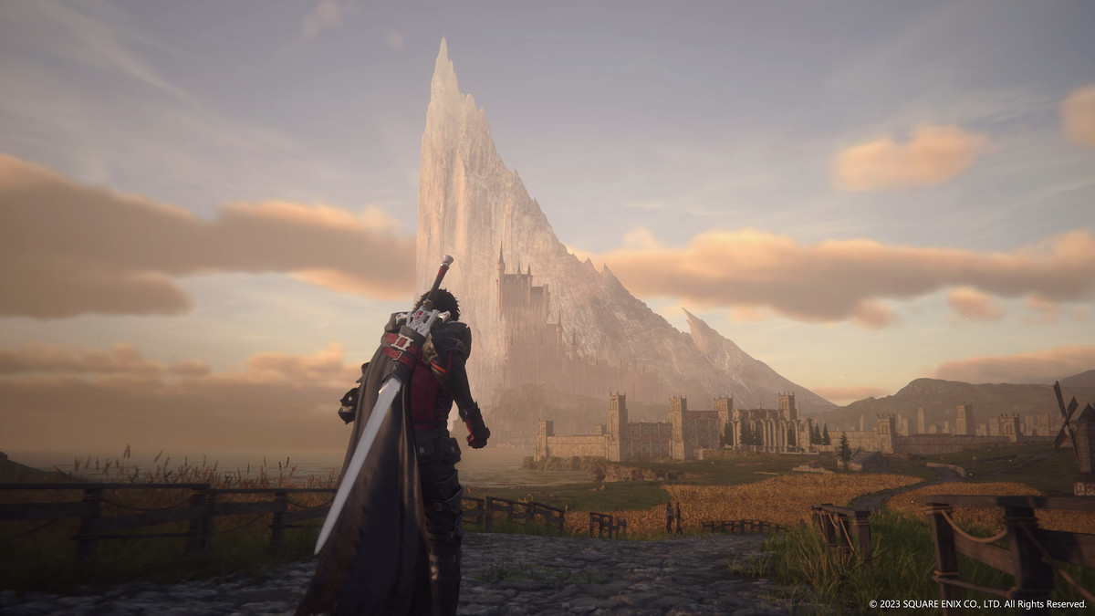 Final Fantasy 16 protagonist Clive Rosfield walks to ward a towering castle in front of a huge, mountain-size crystal with a sword on his back