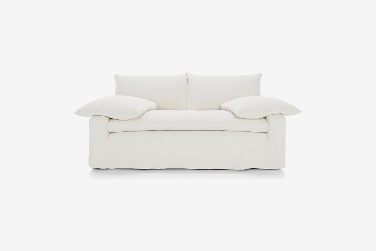 Puffy cream-colored two-seat sofa. 