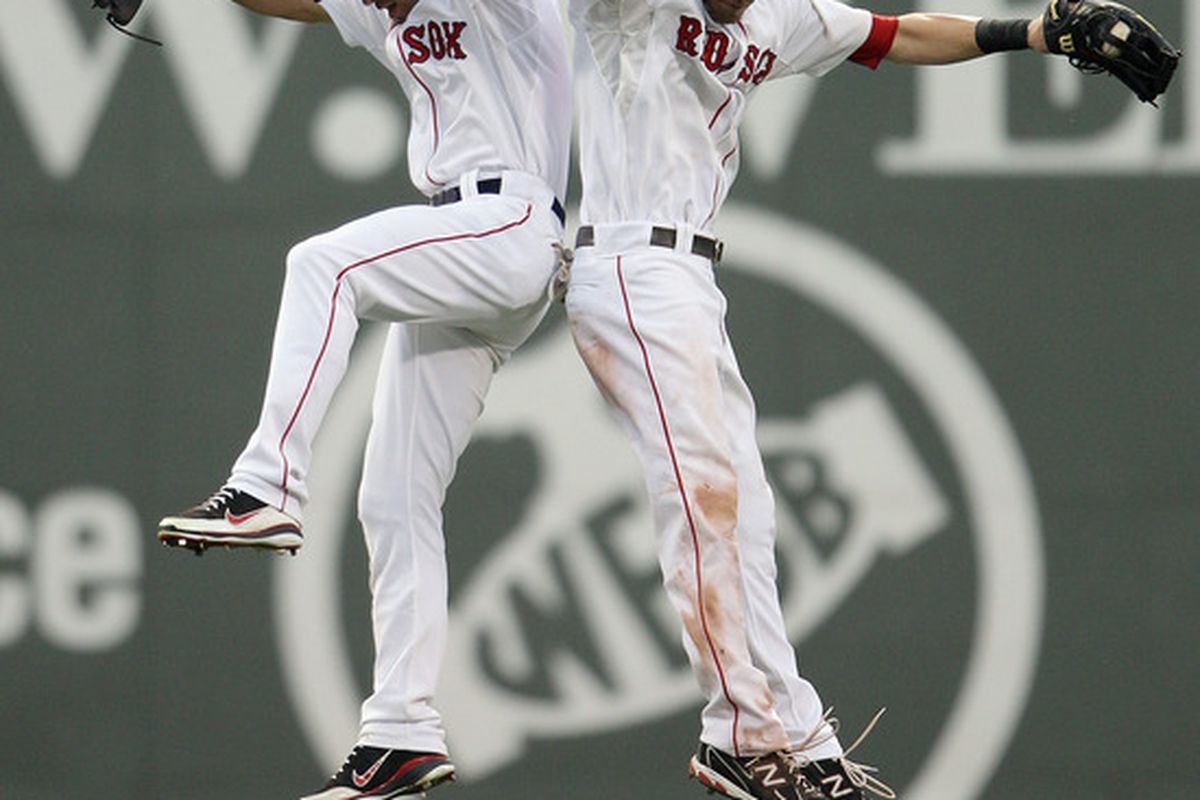 BOSTON, MA - AUGUST 06:  Jacoby Ellsbury #2 of the Boston Red Sox and Josh Reddick #16 celebrate getting a perfect score on Red Sox Trivia at Fenway Park in Boston, Massachusetts.