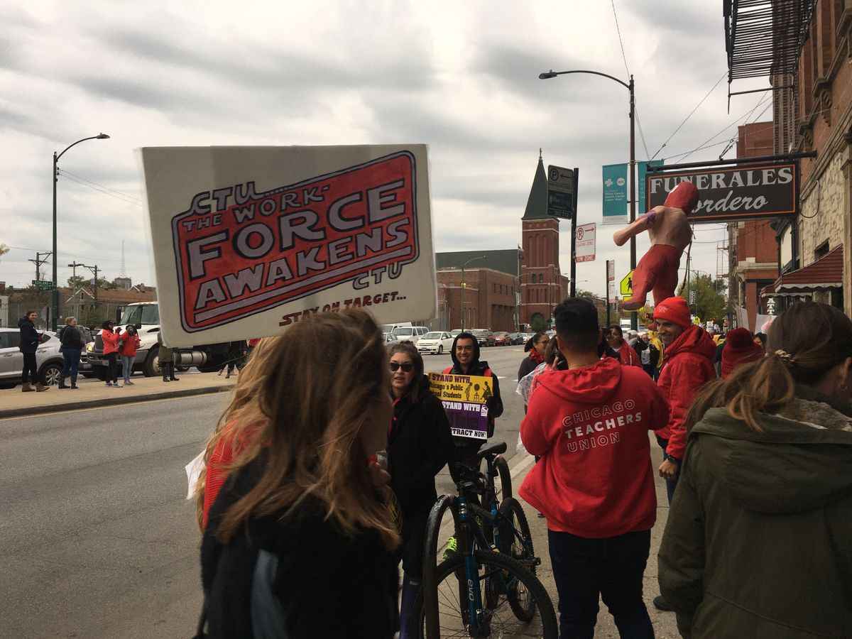 Dozens of teachers, parents and students from Cooper Elementary in Pilsen marched up and down Ashland Avenue on Monday.
