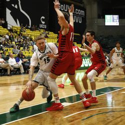Utah Valley guard Jerrelle DeBerry tries to drive around Eastern Washington's Mason Peatling during the first round of the College Basketball Invitational at UCCU Center in Orem on Tuesday, March 13, 2018.