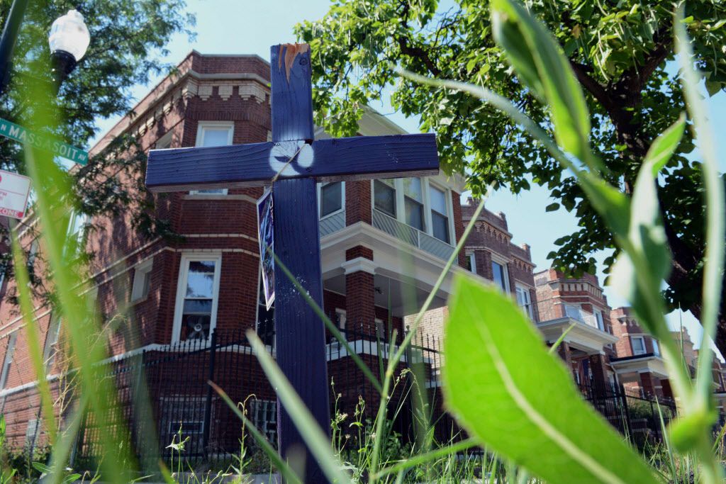 A purple cross, planted at Augusta Boulevard and Massasoit Avenue, marked the scene of another victim of gun violence in Chicago.