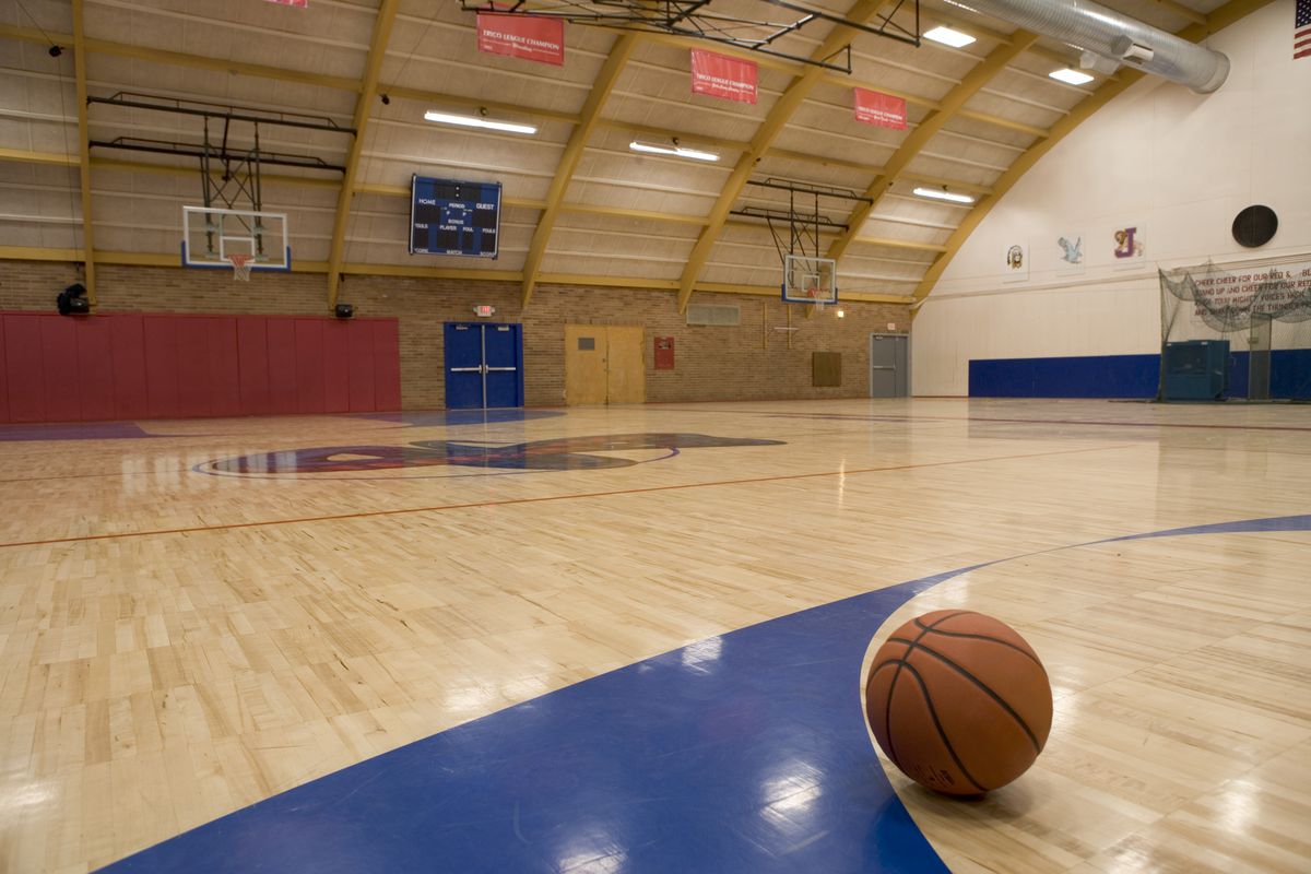 A basketball on a gym floor.