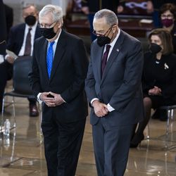 Senate Minority Leader Mitch McConnell of Ky., left, and Senate Majority Leader Chuck Schumer of N.Y., pay their respects to former Senate Majority Leader Harry Reid, D-Nev., during a memorial service in the Rotunda of the U.S. Capitol as Reid lies in state, Wednesday, Jan. 12, 2022, in Washington.