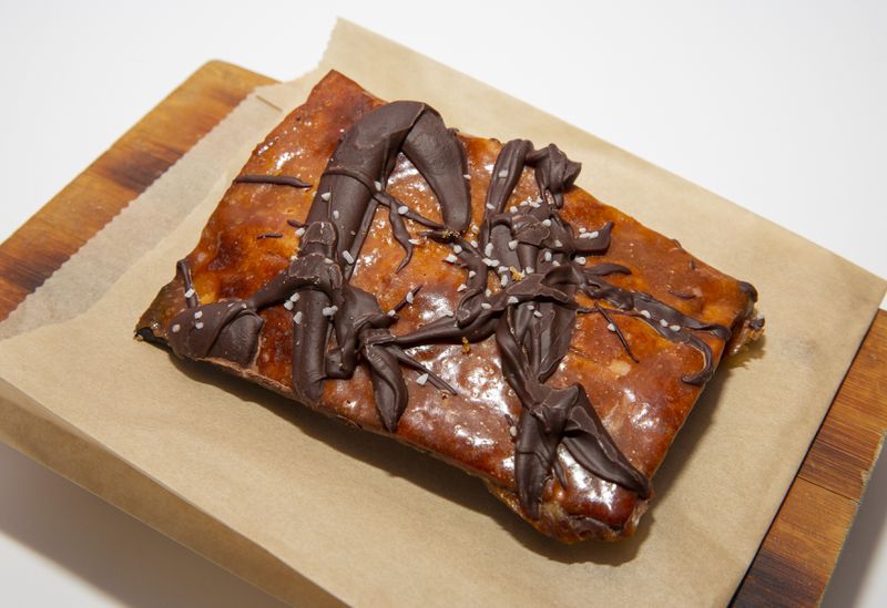 A golden brown piece of toffee-coated matzo with dollops of melted chocolate on top