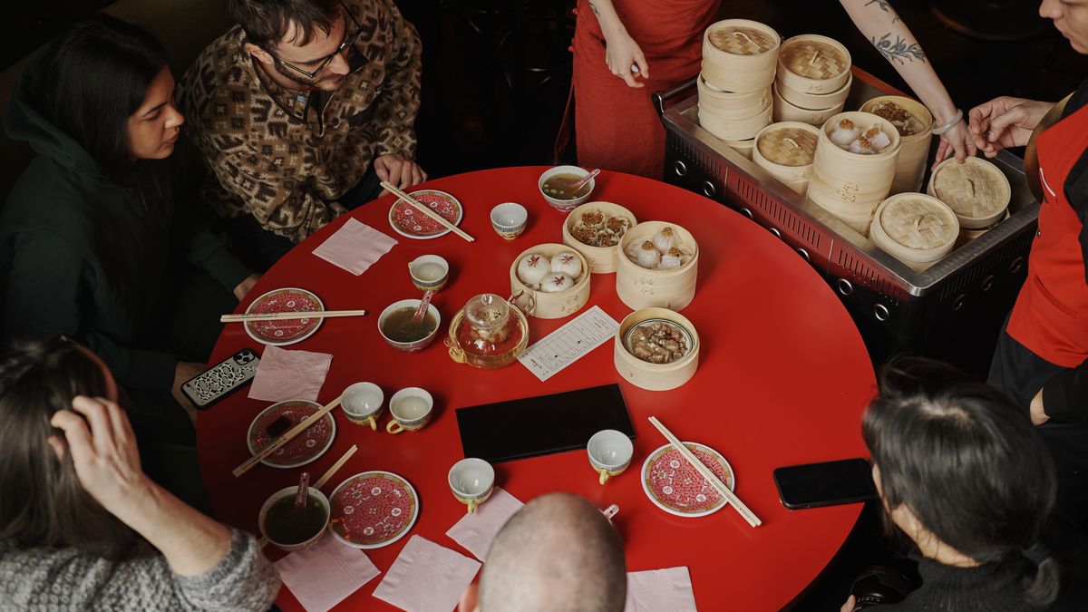 A round red table with diners at Red Pavilion in Bushwick.