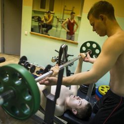 In this photo taken on Friday, Oct. 28, 2016, Russian youths help each other as they lift weights  during training in Verkhnyaya Pyshma, just outside Yekaterinburg, Russia. The training has been run by Yunarmia (Young Army), an organization sponsored by the Russian military that aims to encourage patriotism among the Russian youth. 