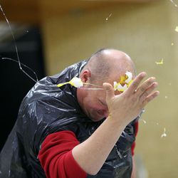 Principal Jonathan Gochberg smashes a raw egg against his head while playing Egg Russian Roulette at the Penny Wars Assembly at Sunset Junior High in Sunset on Wednesday, Dec. 21, 2016. Students raised $8,300 in five days doing a penny wars competition between seventh-, eighth- and ninth-graders to help families who can't afford Christmas.