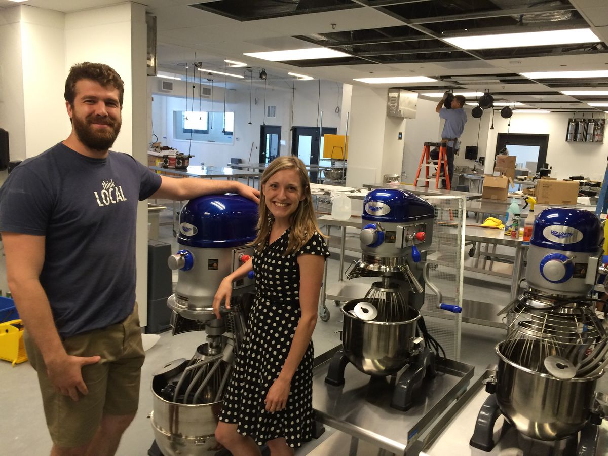 Union Kitchen's Cullen Gilchrist and Mary Beth Marks pose with industrial, kitchen mixers coming to the new Ivy City Space / Photo by Tim Ebner