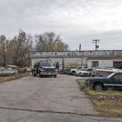 A worker secures a car to a tow truck at Aloha Towing at 275 W. High Ave. in Salt Lake City on Tuesday, Dec. 13, 2016. Mayor Jackie Biskupski and the City Council announced the sites of four new homeless resource centers, including 275 W. High Ave. The shelters will be designed to provide comprehensive services for people experiencing homelessness and other challenges.