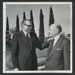 Elder L. Tom Perry, left, and Elder Howard W. Hunter visit on Mesa Arizona Temple grounds before the temple's rededication, April 1975.