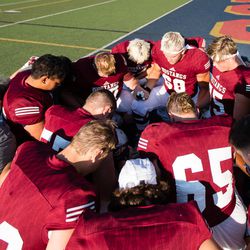 Herriman High School Football team prays before the game against Lone Peak. plays Lone Peak High School at Herriman on Friday, Aug. 18, 2017.