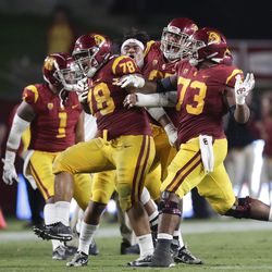 Southern California defensive lineman Jay Tufele (78) and teammates celebrate after Tufele blocked a kick by Washington State punter Blake Mazza during the second half of an NCAA college football game, Friday, Sept. 21, 2018, in Los Angeles. 