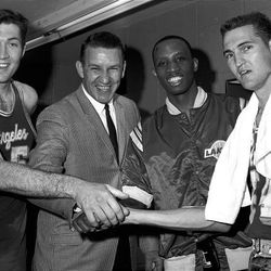 In this April 14, 1965, file photo, Los Angeles Lakers coach Fred Schaus, second from left, congratulates three Lakers, from left to right, Rudy LaRusso, Dick Barnett and Jerry West, after the team won the NBA Western Division basketball playoffs in Baltimore. Schaus died Wednesday night.