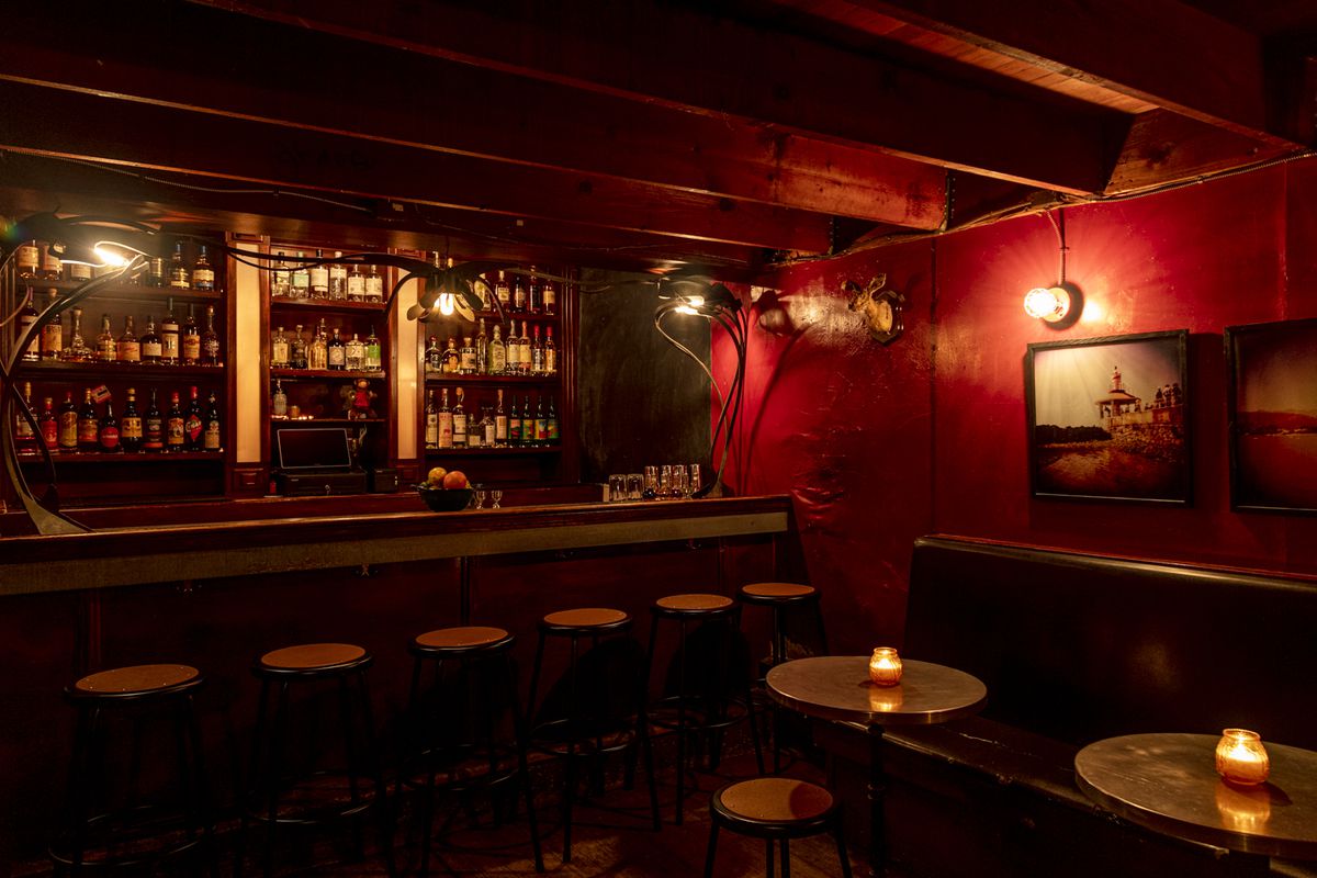 The bar at the Hideout with red walls and dim lighting.