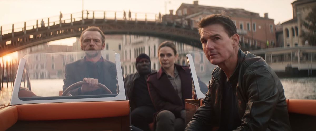 Tom Cruise in a boat with Simon Pegg, Ving Rhames, and Rebecca Ferguson for Mission: Impossible Dead Reckoning Part 1