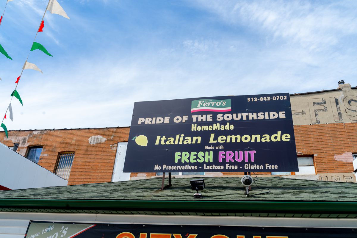 A black billboard sign on a rooftop reads “Ferro’s Pride of the Southside HomeMade Italian Lemonade.”