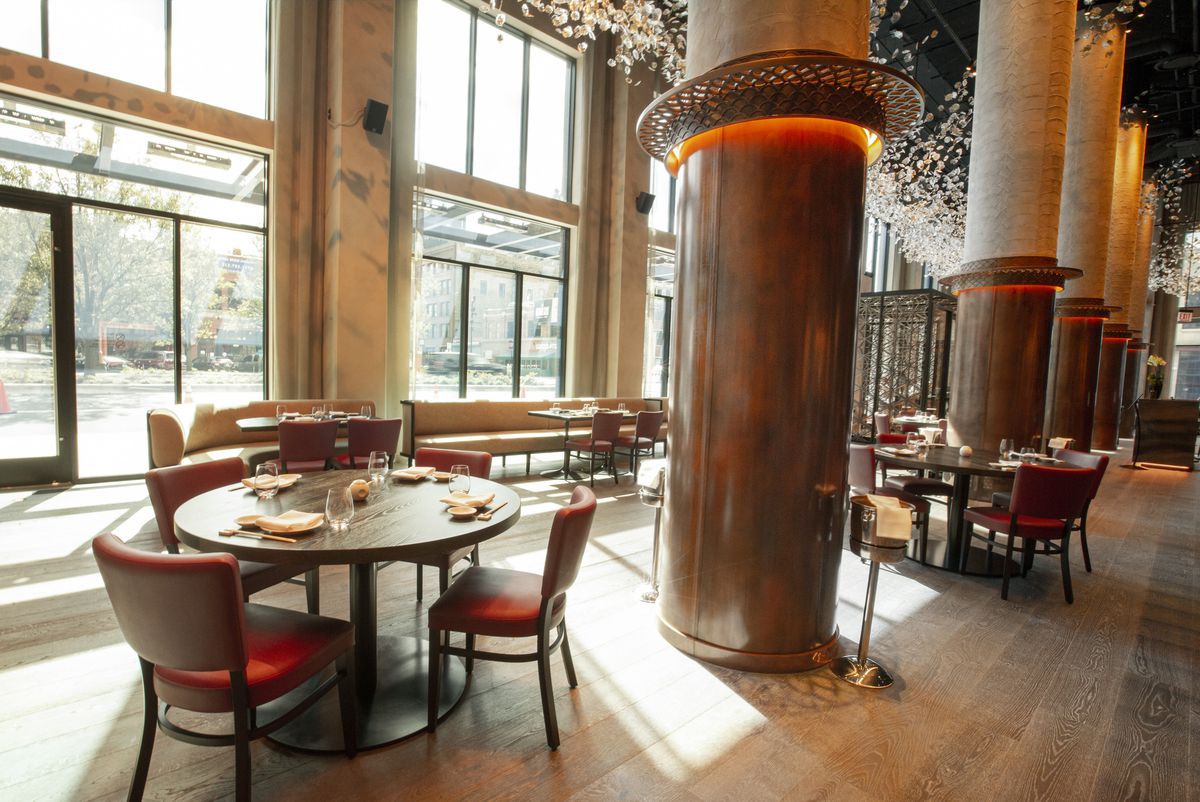 Nobu Chicago’s dining room has earthy tones, and red leather seats.