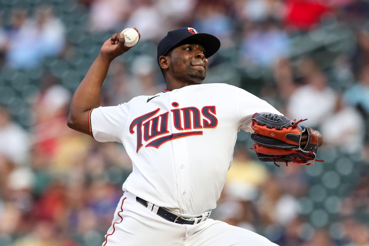 Jharel Cotton reaching back to throw a pitch in a Twins jersey