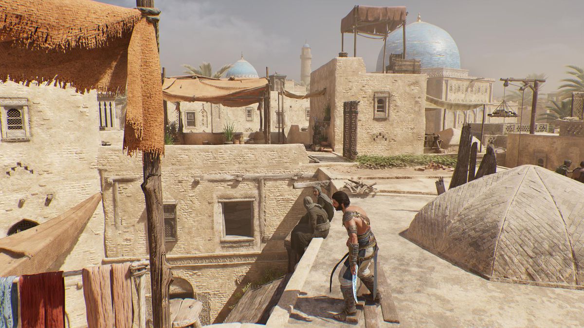 Basim stands on the roof of a building in Harbiyah looking for a Lost Book in AC Mirage.