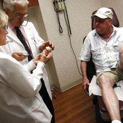 Kathy Miller, RN, Dr. John Zone and Lester Crow discuss Crow 's numerous prescriptions  at University Hospital  on Wednesday, September 7, 2011.  Lester Crow  has a rare condition called pemphigus vulgaris.
