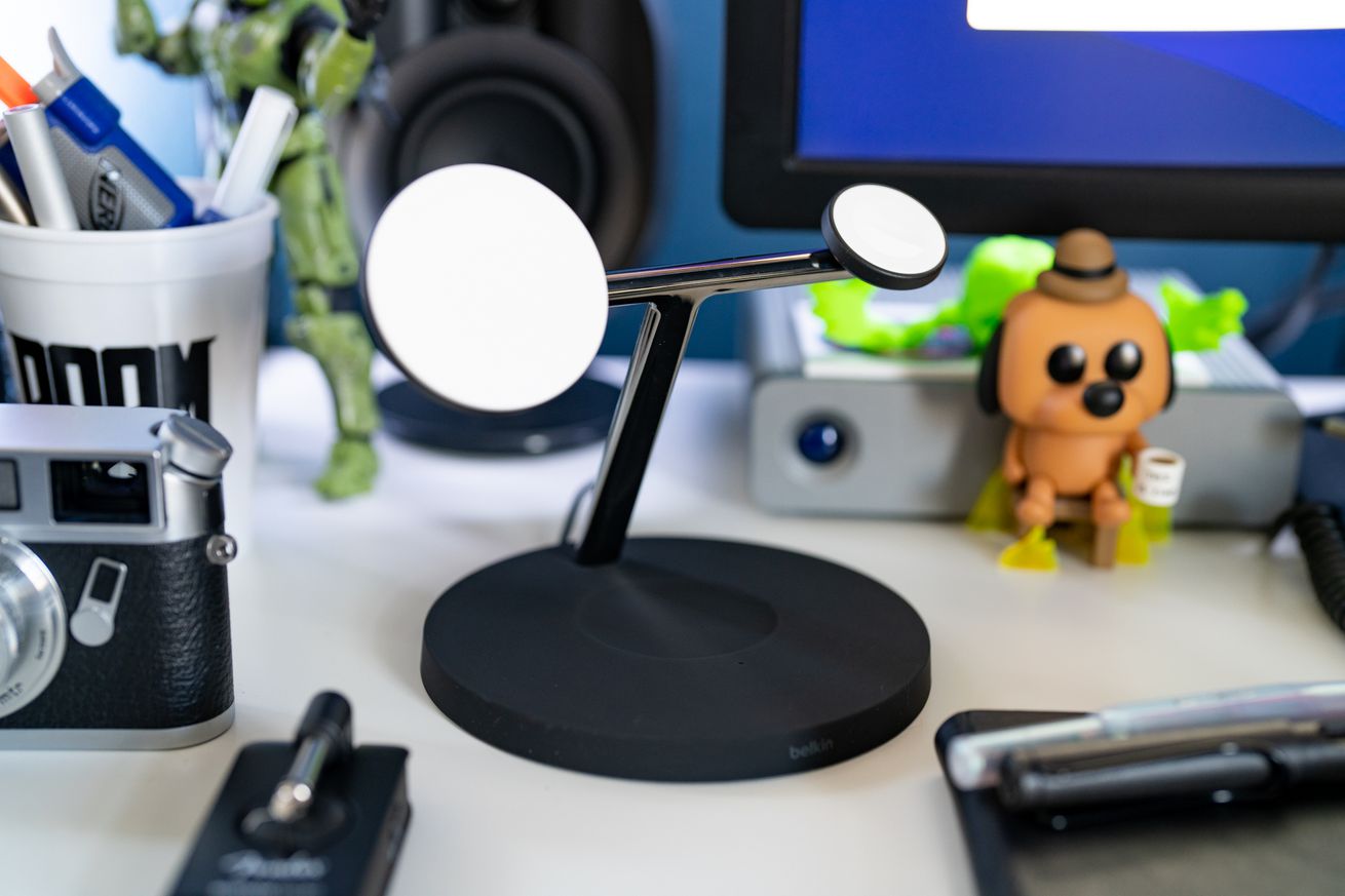 The black version of Belkin’s BoostCharge Pro with MagSafe sitting on a cluttered desk.