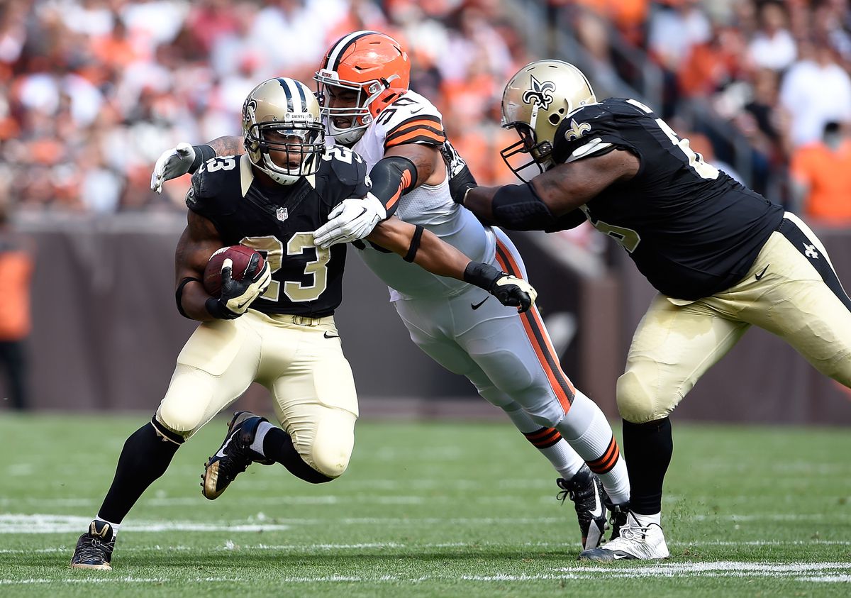 CLEVELAND, OH - Former New Orleans Saints running back Pierre Thomas (23) evades a tackle by Cleveland Browns defensive lineman Billy Winn (90) at FirstEnergy Stadium.