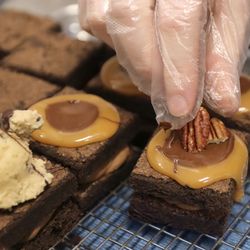 Molly Kohrman, Owner of Brownies!  Brownies!  Brownies !, adds Turtle Brownie Toppings at Salt Lake City Bakery on Tuesday, December 22, 2020.