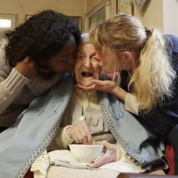 Emma Morano, 117 years hold, is kissed by her caretakers Malgorzat Ceglinska, right, and Yamilec Vergara, in the day of her birthday in Verbania, Italy, Tuesday, Nov. 29, 2016.  At 117 years of age, Emma is now the oldest person in the world and is believed to be the last surviving person in the world who was born in the 1800s, coming into the world on Nov. 29, 1899.